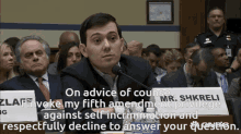 a man sitting in front of a sign that says on advice of counsel