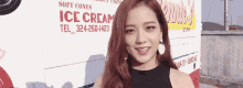 a woman standing in front of an ice cream truck that says soft cones ice cream