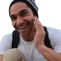 a man wearing a beanie and a white shirt smiles