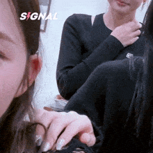 two women are sitting next to each other and the word signal is on the bottom