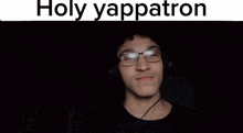 a man wearing headphones covering his face with his hand and the words holy yappatron written above him