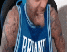 a man with tattoos is wearing a blue jersey that says brian