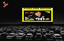 a poster for the steelers nation is displayed in a parking lot