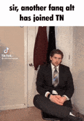 a man in a suit and tie is sitting on a chair with his legs crossed and a caption that says sir another fang alt