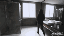 a woman standing in a bathroom with the words made in animotica on the bottom right