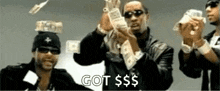 a group of men are holding a bunch of money in their hands and throwing it in the air .