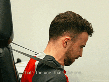 a man with a rubber band around his neck says " that 's the one "