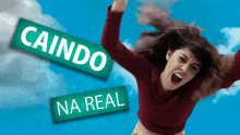 a woman with her arms in the air and a sign that says caindo na real