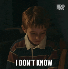 a young boy in a striped shirt says i don t know