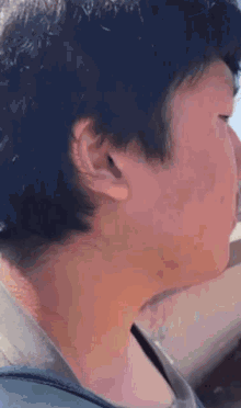 a close up of a person 's ear with a blue background