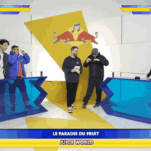 a group of men are standing in front of a sign that says le paradis du fruit
