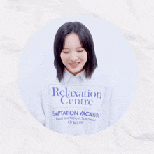 a woman wearing a relaxation centre shirt is smiling with her eyes closed