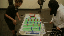 juice wrld plays a game of foosball with other people