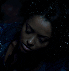 a close up of a woman 's face with sparkles on her face