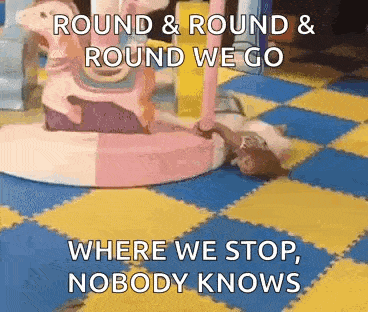 a girl is laying on the floor in a room with a carousel and a quote .