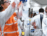 a man in an orange vest has a sticker on his vest that says ' ambulance '