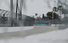 a race car is going down a track with a sign that says ' california ' on it
