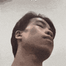 a close up of a man 's face with a blurred background