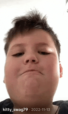 a close up of a boy 's face with the date 2022-11-12