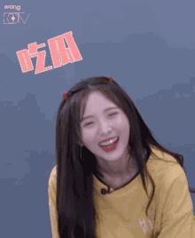 a girl wearing a yellow shirt that says high five on it