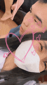a man and a woman wearing masks with hearts drawn on their faces