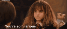 hermione granger from harry potter is talking to a man while wearing a school uniform .