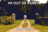 a man is walking down a dirt road with a sign that says `` im out of here ! ''