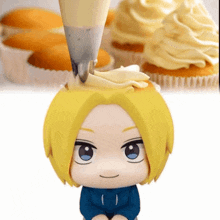 a figurine of a boy with frosting being poured on his head