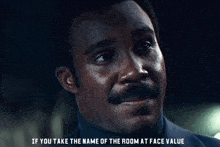 a close up of a man with the words if you take the name of the room at face value below him