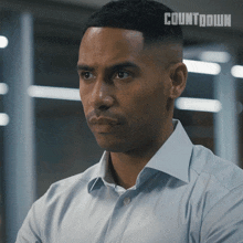 a man wearing a white shirt with the word countdown on it
