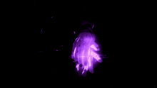 a purple glowing object in the dark with the letter j visible