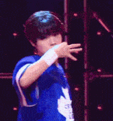 a young man is wearing a blue jersey with the number 25 on it .