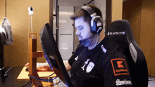 a man wearing headphones and a shirt that says blacklyte