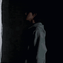 a silhouette of a man standing in front of a brick wall