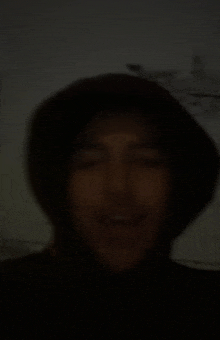 a blurry picture of a man wearing a black hat