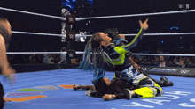 two women are wrestling in a wrestling ring with a sign that says ' smack ' on it