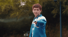 a young man in a blue and white jacket with the letter b on it