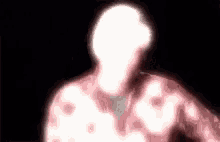 a blurry picture of a man 's face with a white light coming out of it .