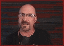 a man wearing glasses and a shirt that says cas is pointing