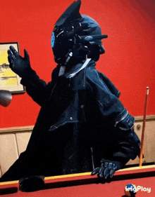 a man in a futuristic helmet is playing pool