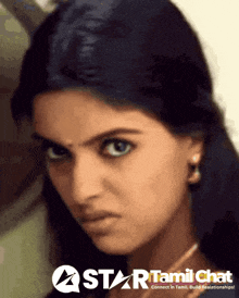 a close up of a woman 's face with a star tamil chat logo in the corner