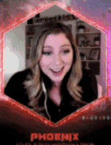 a woman wearing headphones is smiling in front of a phoenix logo