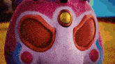 a close up of a stuffed animal with a gold circle on its head