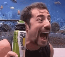 a man with his mouth open is holding a can that says b on it