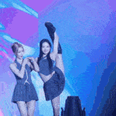 a girl in a pleated skirt is doing a split on stage