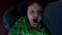 a child yawning in a car seat with his mouth wide open