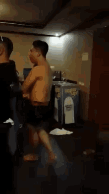a group of men are standing in a room .