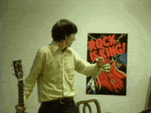 a man standing in front of a rock is king poster