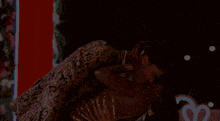a man is holding a woman in his arms and kissing her on the cheek