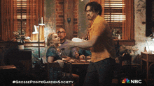 a nbc ad for grosse pointe garden society shows a man holding a cake